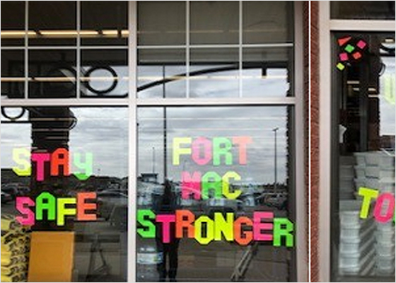 Store window displaying cut-out letters reading 