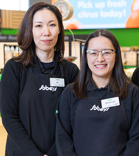 Three Sobeys store employees standing in the produce department