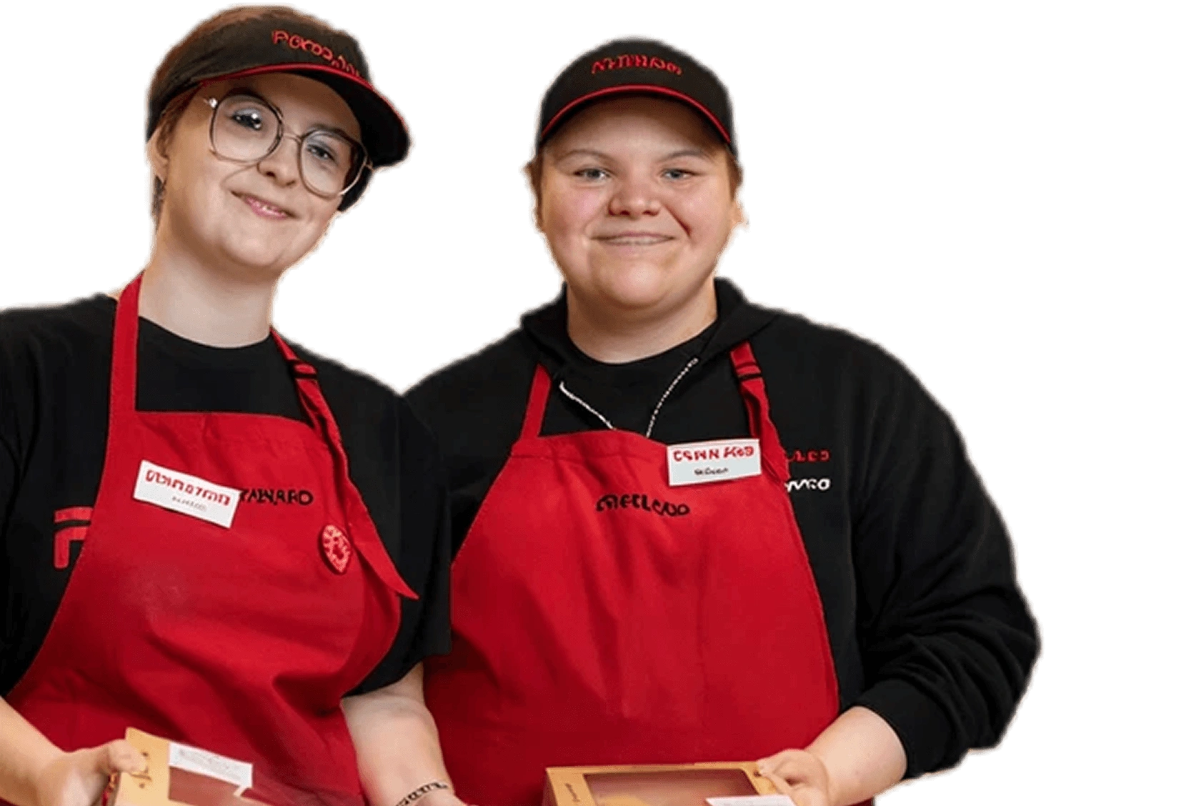 Two grocery store employees in uniform holding boxed goods.