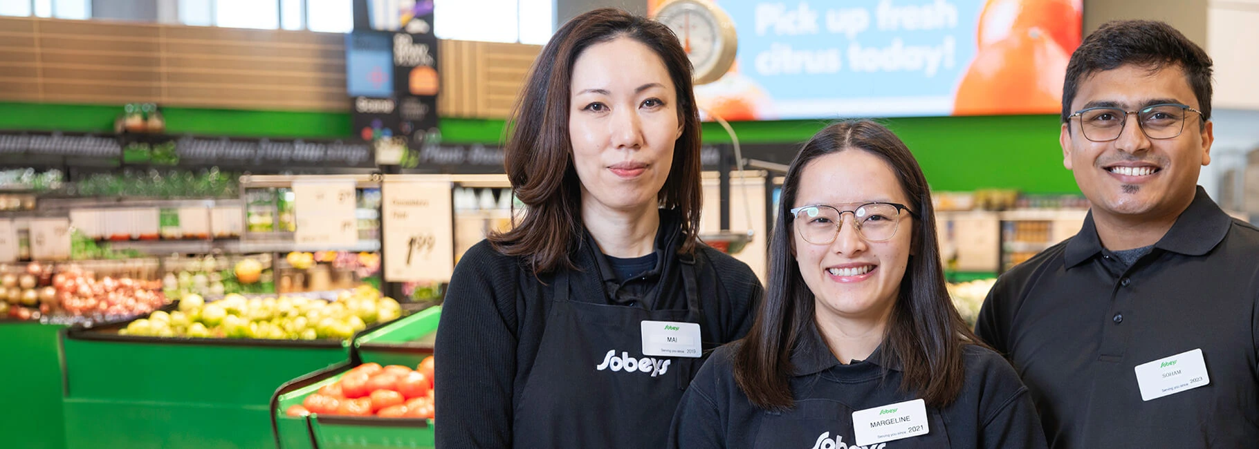 Three Sobeys store employees standing in the produce department