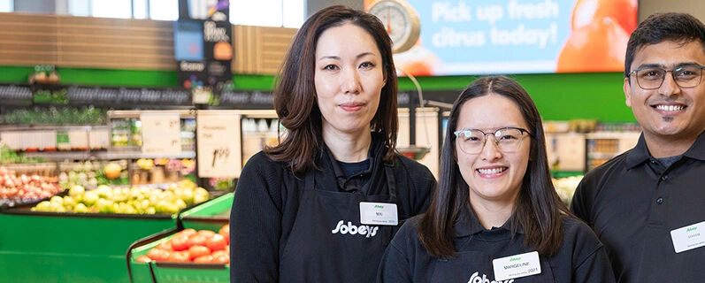 Three Sobeys store employees standing in the produce department